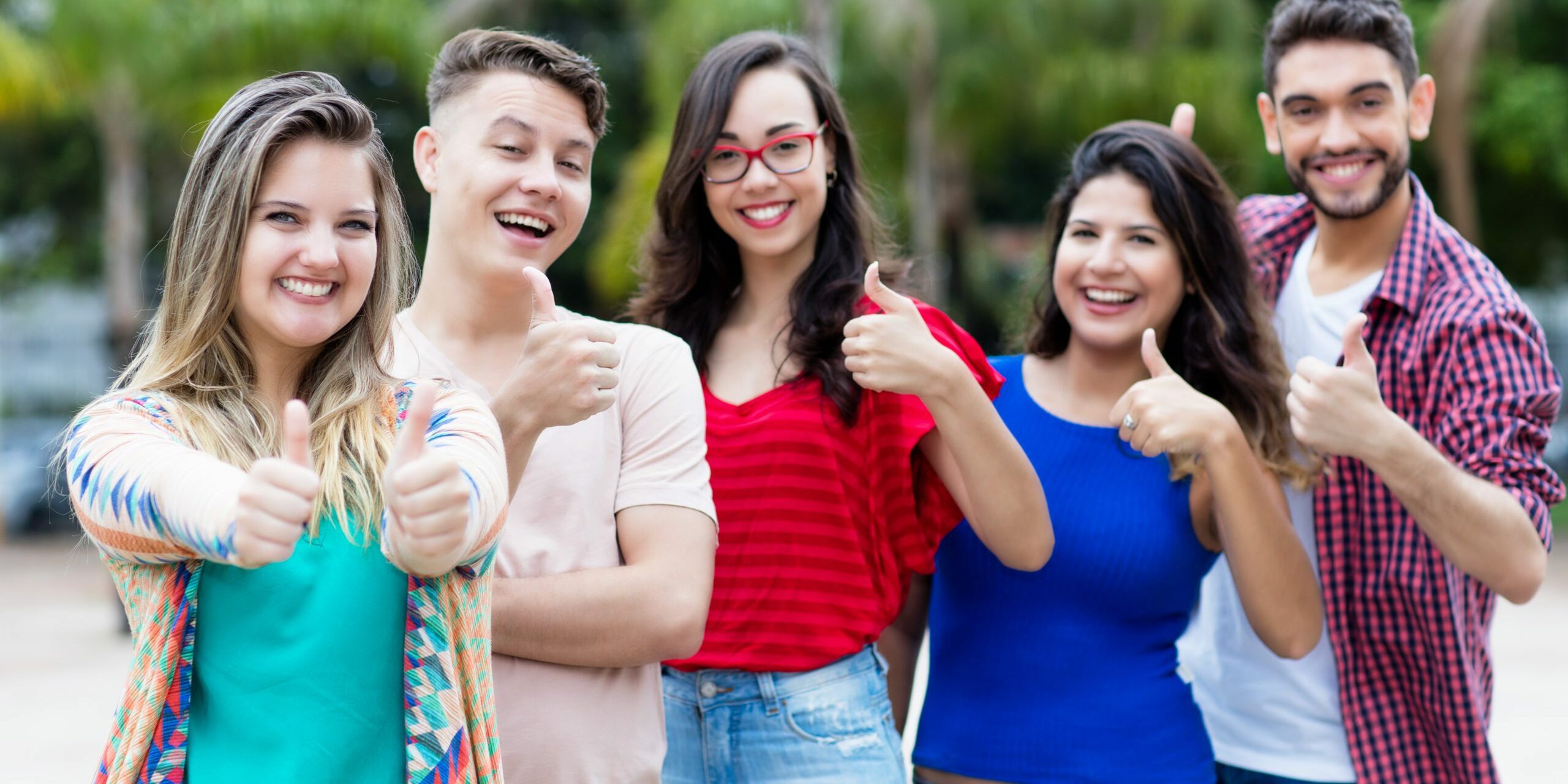 Dutch young adult woman with group of friends in line outdoor in the city in summer