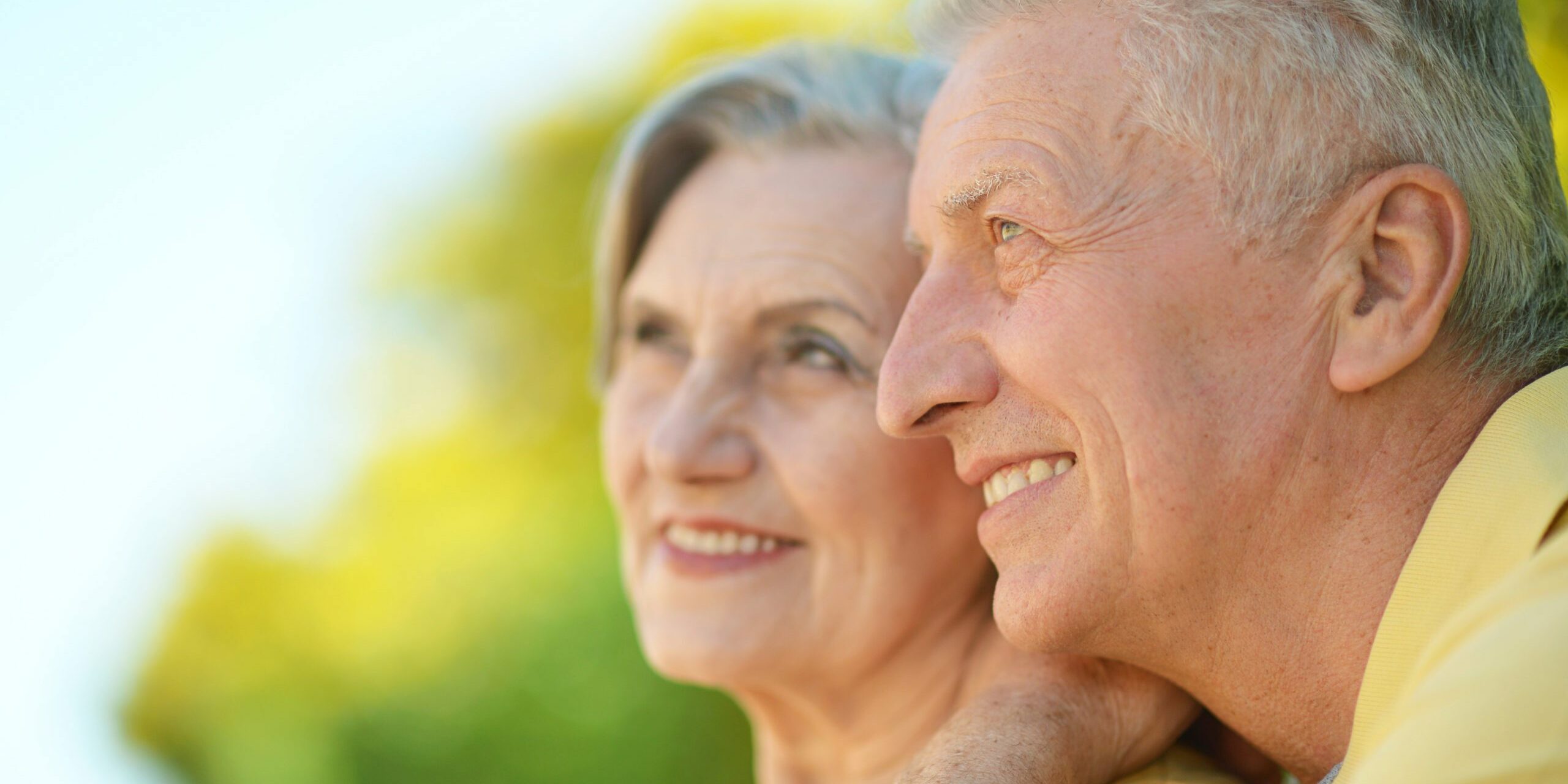 Portrait of beautiful elderly couple outdoor in summer park